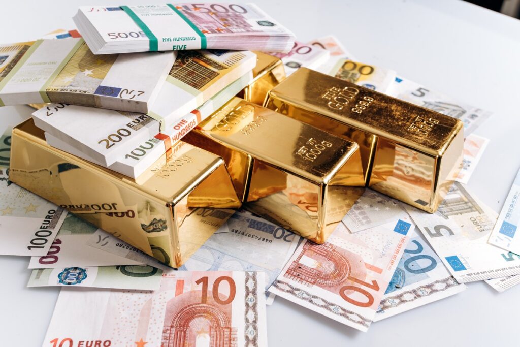 Gold bullions at euro banknotes closeup background